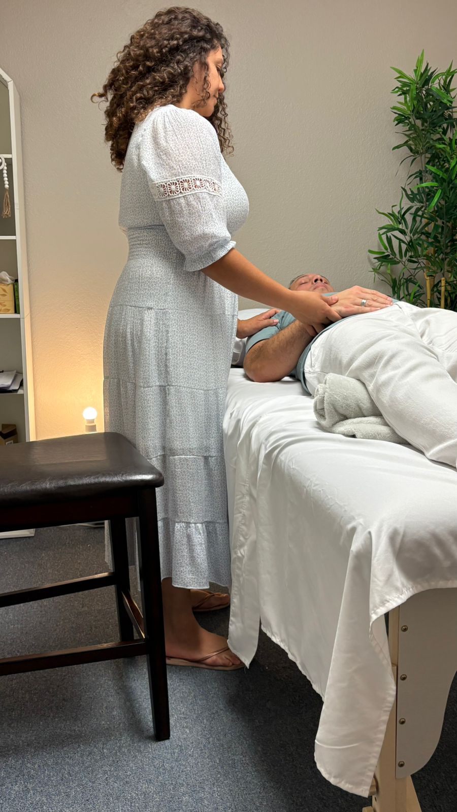 Naiça Bowen giving a BodyTalk session to a client in her St. Petersburg practice room